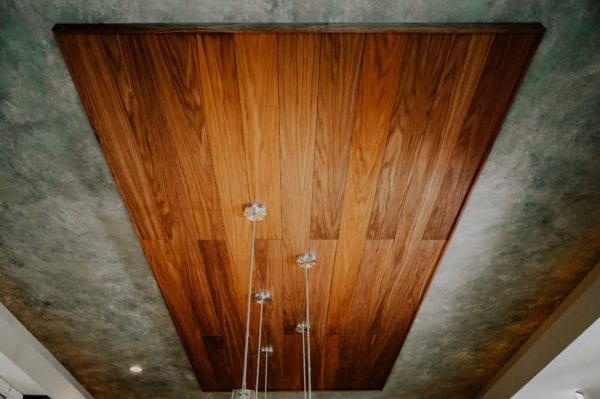 Walnut acoustic wood planks featured on a kitchen ceiling.
