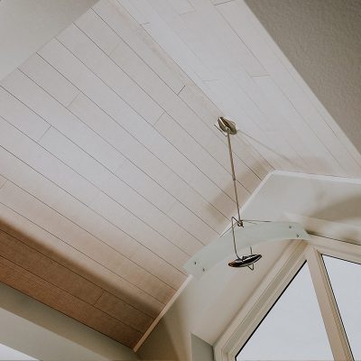Vaulted ceiling featuring whitewash oak acoustic planks